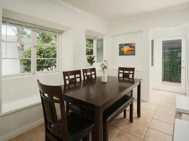 a view of a dining room with furniture and window