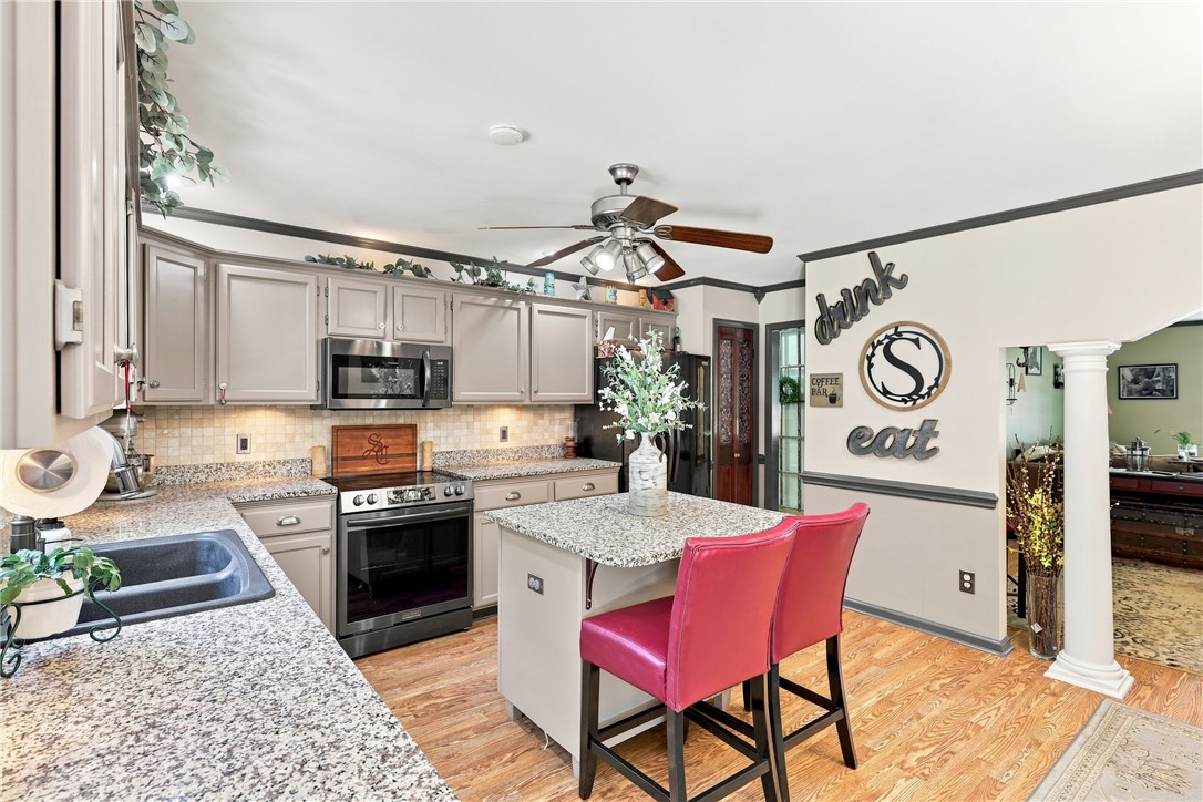 1009 Willow Run Anderson, SC 29621 - Photo 13 of 46 Polished granite countertops and classic cabinetry anchor this well-appointed kitchen over rich wood floors.
