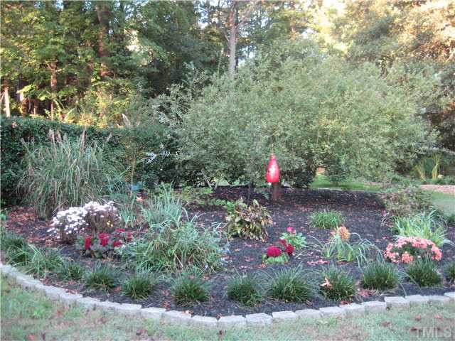 157 Ridge Drive Garner, NC 27529 - Photo 21 of 25 One example of the beautiful flower beds that abound this property!