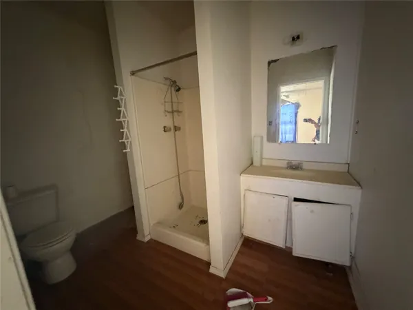 a bathroom with a sink a toilet and a mirror