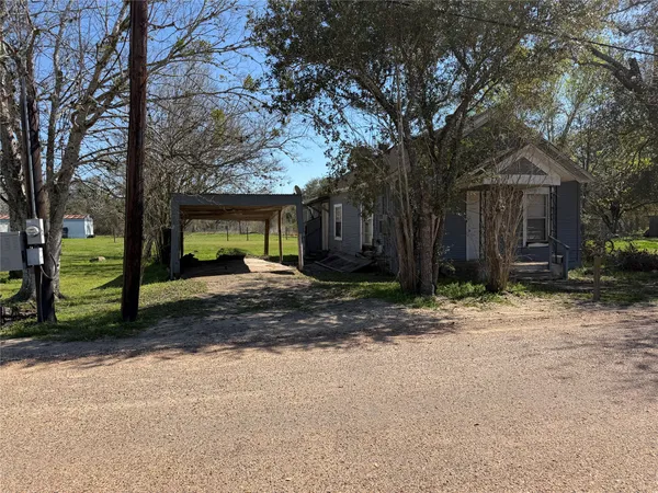 a view of a house with a yard and tree s