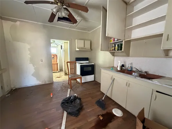 a kitchen with stainless steel appliances a stove a sink and cabinets