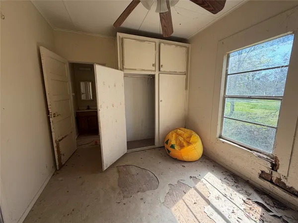 a bedroom with a bed and a window