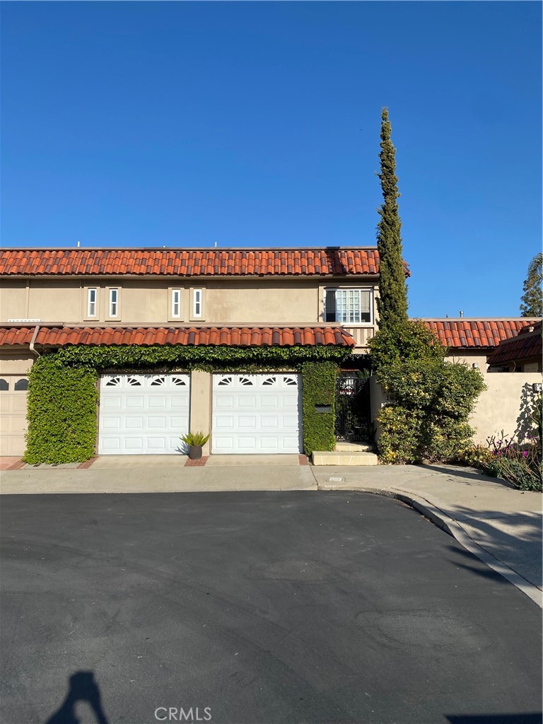 16 Seton Road Irvine, CA 92612 - Photo 1 of 31 a front view of a building with a garden and parking