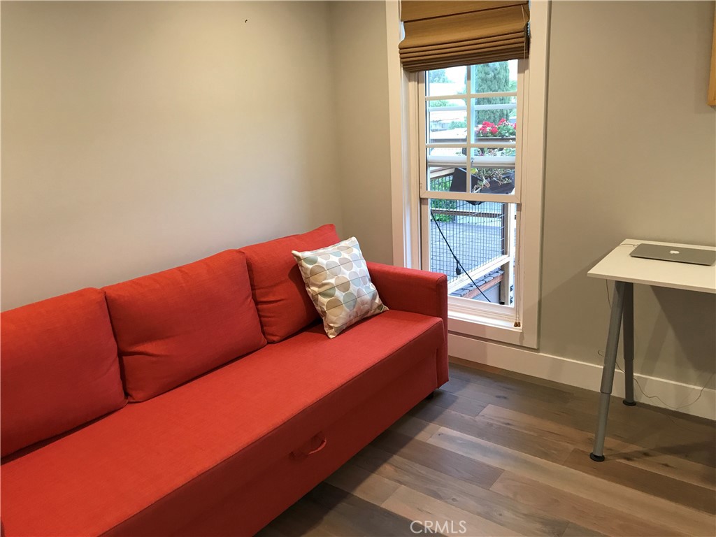 16 Seton Road Irvine, CA 92612 - Photo 23 of 31 a blue couch sitting in a living room next to a window