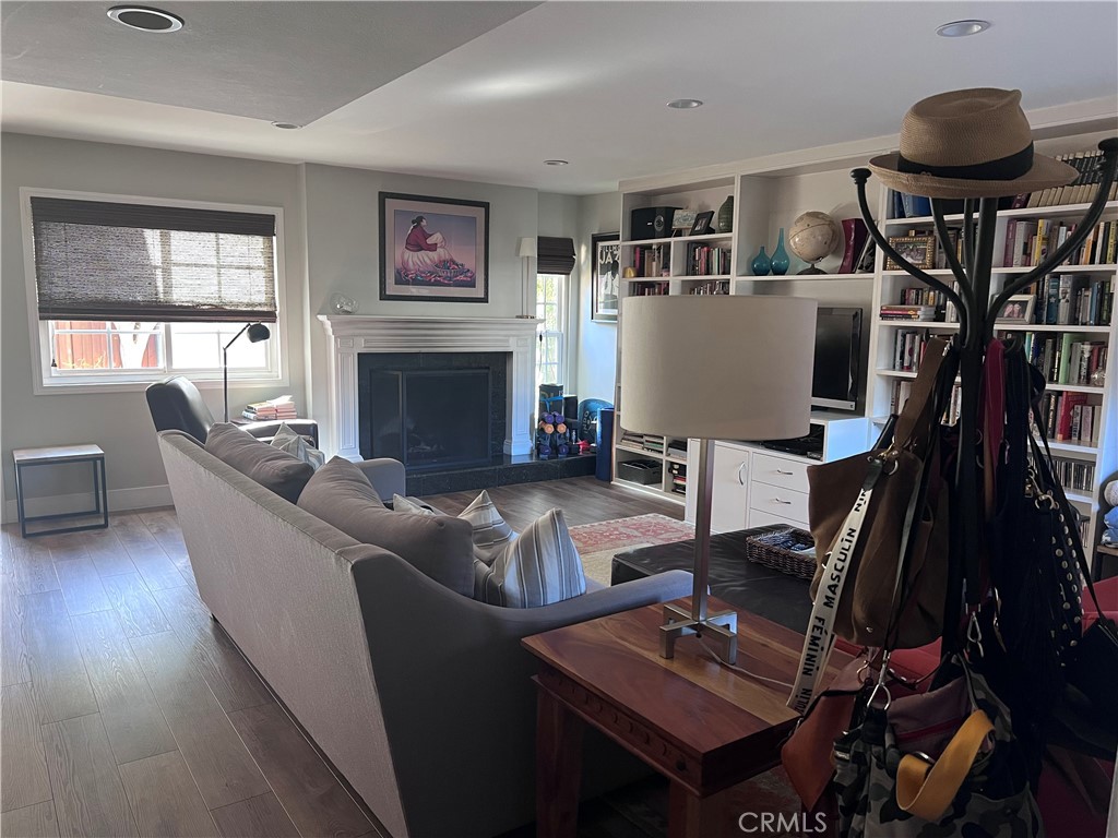 16 Seton Road Irvine, CA 92612 - Photo 4 of 31 a living room with furniture a fireplace and a flat screen tv