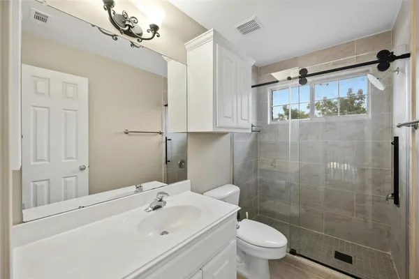 a bathroom with a shower and a toilet