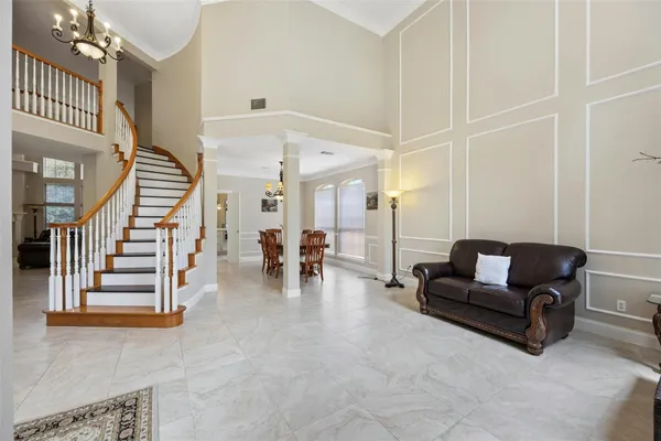 a living room with furniture and a chandelier