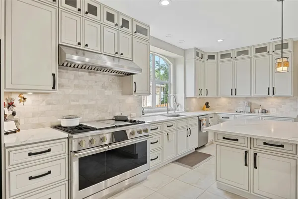 a kitchen with white cabinets and white appliances
