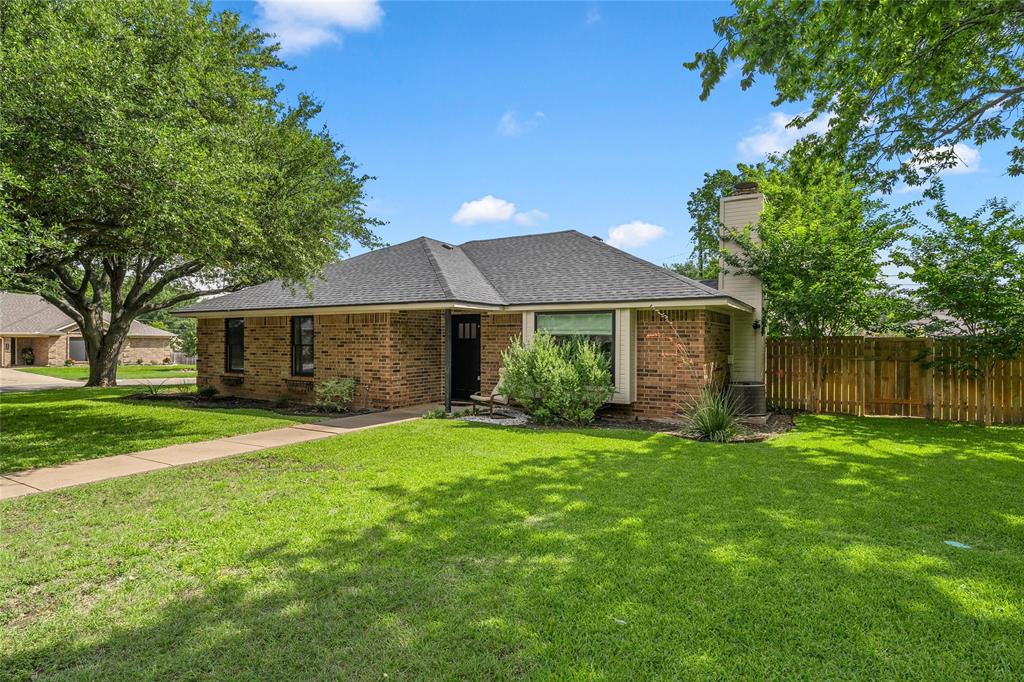 310 Ruth Drive Hewitt, TX 76643 - Photo 3 of 25 Brick exterior with a dark shingle roof and prominent chimney