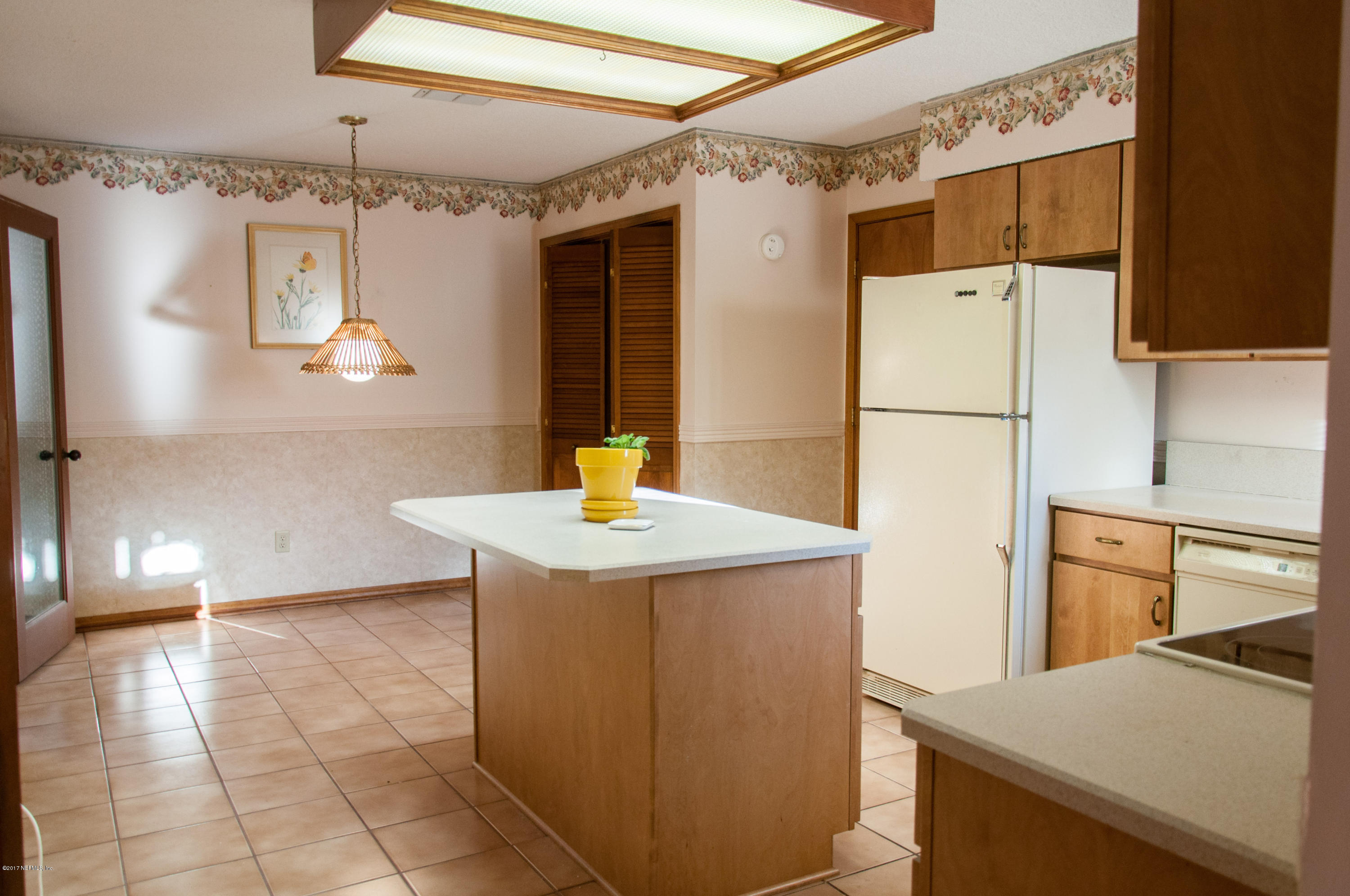 5461 Spring Brook Road Jacksonville, FL 32277 - Photo 12 of 38 a kitchen that has a sink a refrigerator and a stove top oven