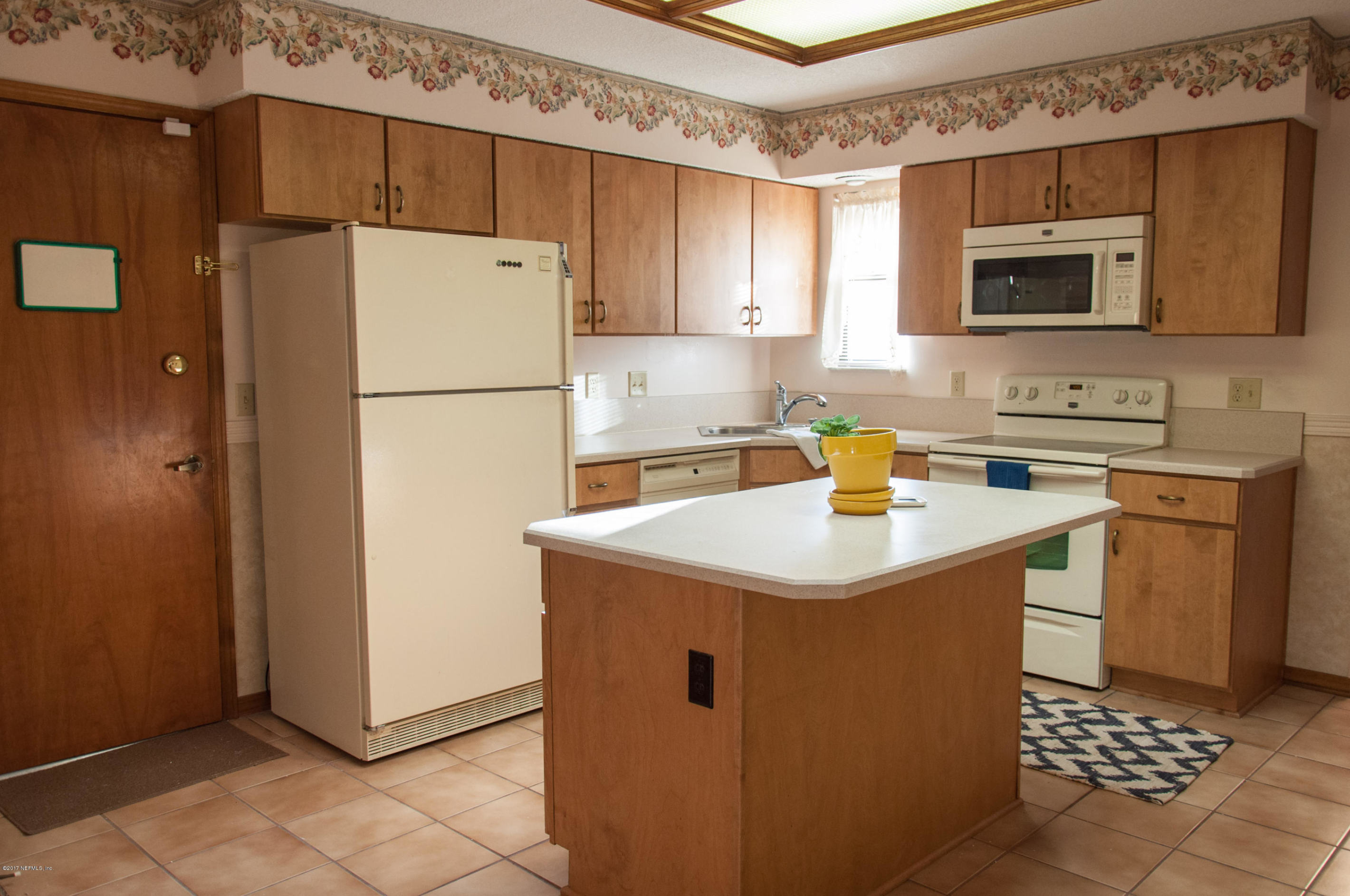 5461 Spring Brook Road Jacksonville, FL 32277 - Photo 13 of 38 a kitchen with a sink a stove a refrigerator and a sink