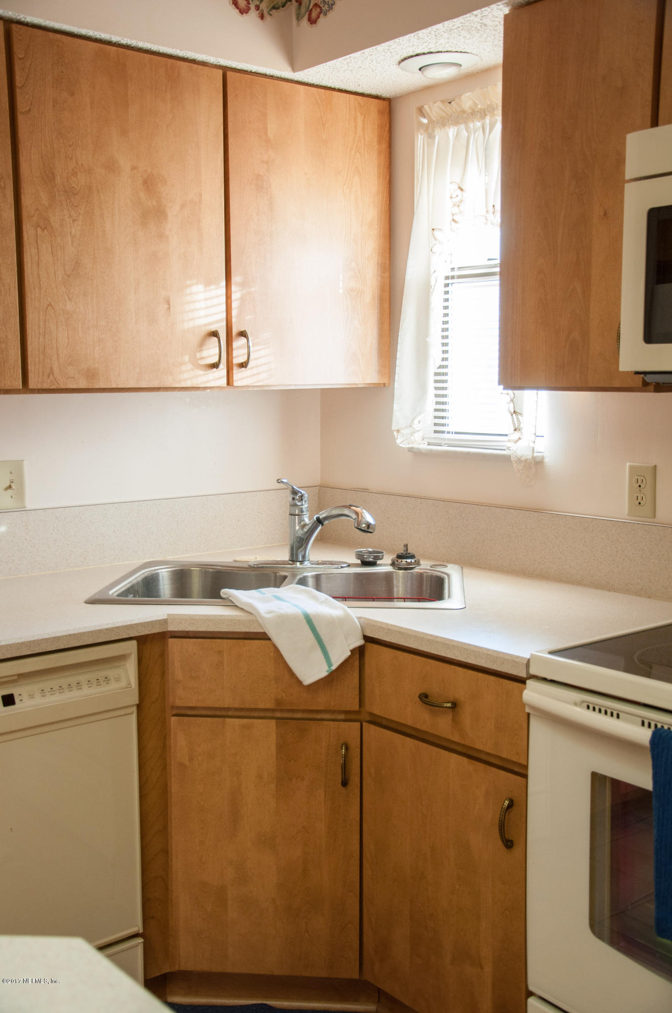 5461 Spring Brook Road Jacksonville, FL 32277 - Photo 14 of 38 a utility room with a sink a washer and dryer next to a window