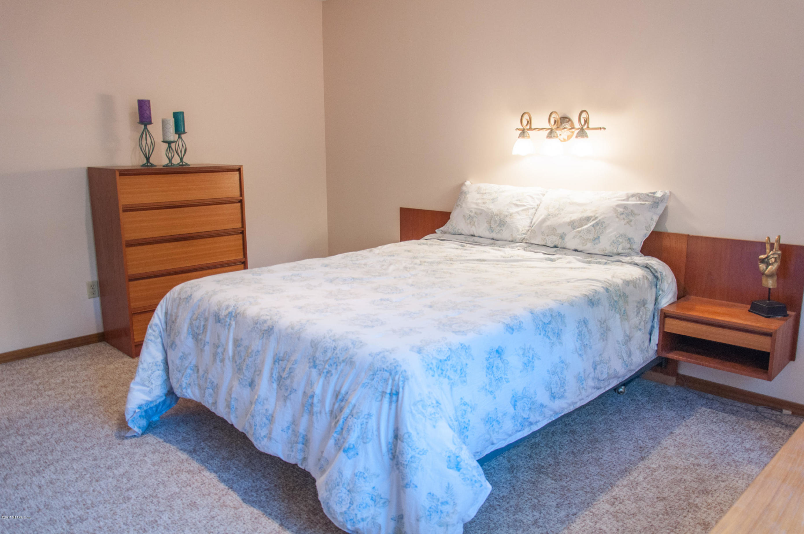 5461 Spring Brook Road Jacksonville, FL 32277 - Photo 20 of 38 a bedroom with a bed and a dresser