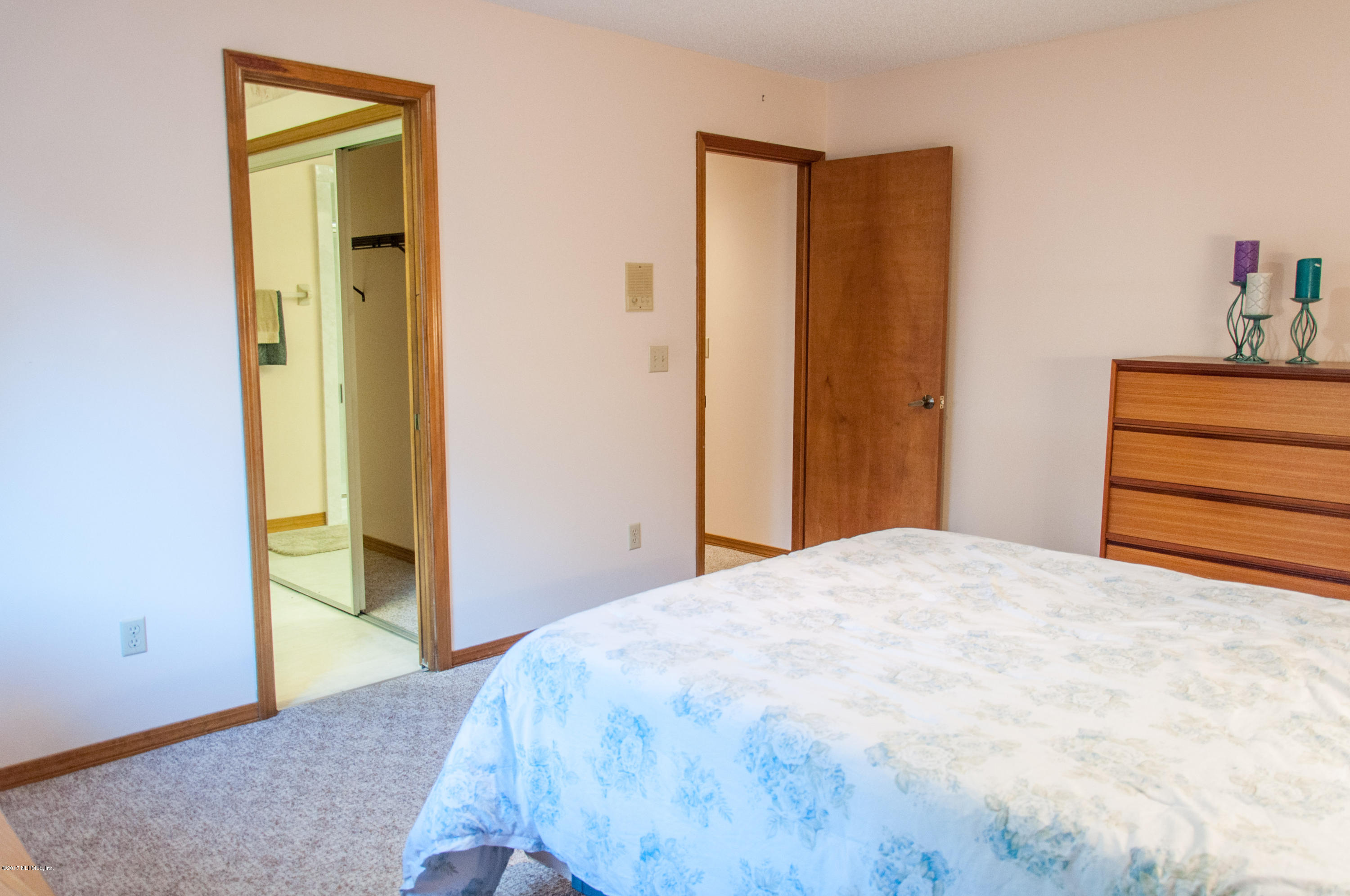 5461 Spring Brook Road Jacksonville, FL 32277 - Photo 21 of 38 a bedroom with a bed and wooden floor