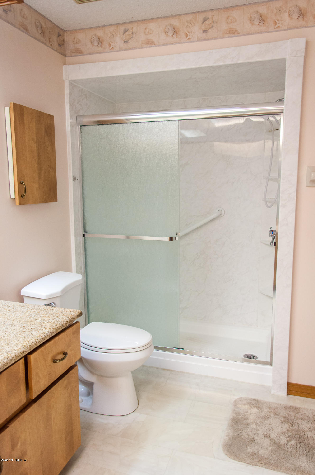 5461 Spring Brook Road Jacksonville, FL 32277 - Photo 23 of 38 a bathroom with a granite countertop sink mirror vanity and toilet