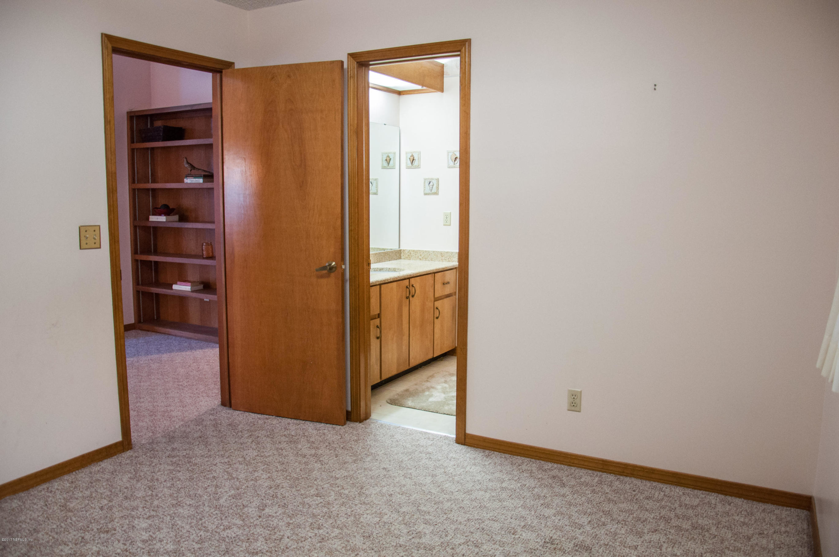 5461 Spring Brook Road Jacksonville, FL 32277 - Photo 27 of 38 an empty room with closet and mirror