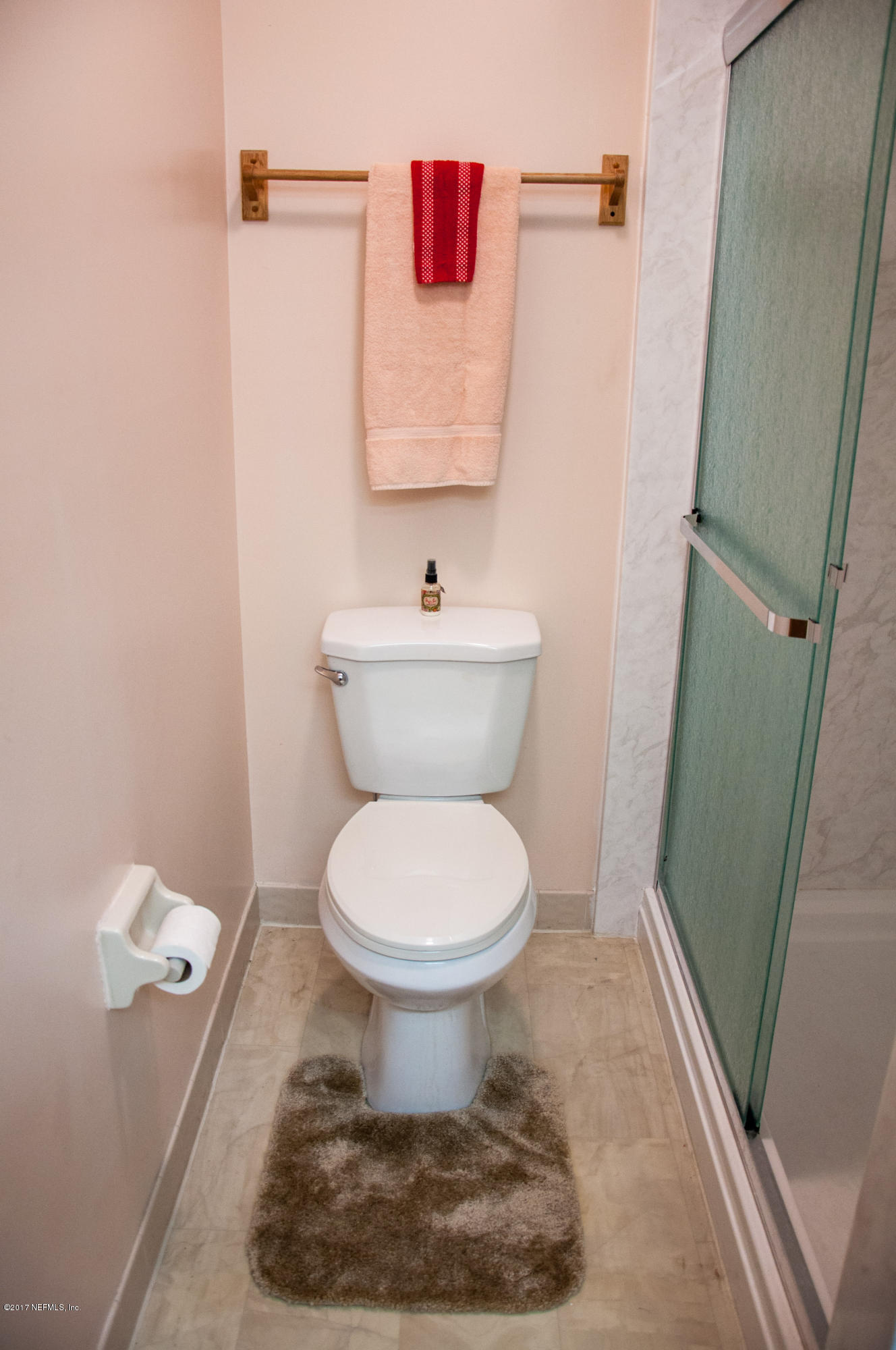 5461 Spring Brook Road Jacksonville, FL 32277 - Photo 28 of 38 a bathroom with a toilet and a shower