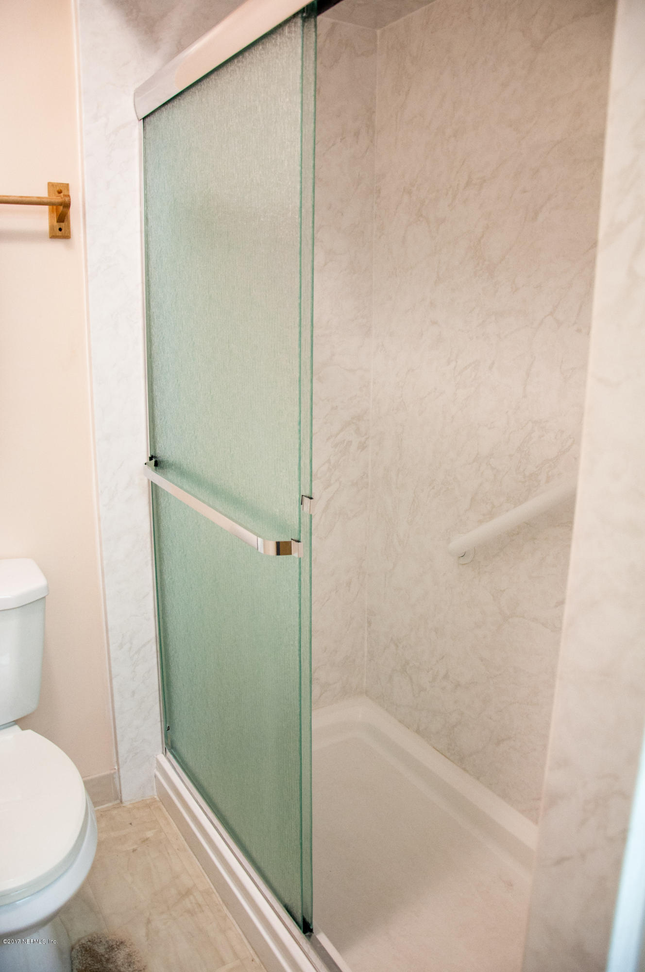 5461 Spring Brook Road Jacksonville, FL 32277 - Photo 29 of 38 a bathroom with a granite countertop bathtub and toilet