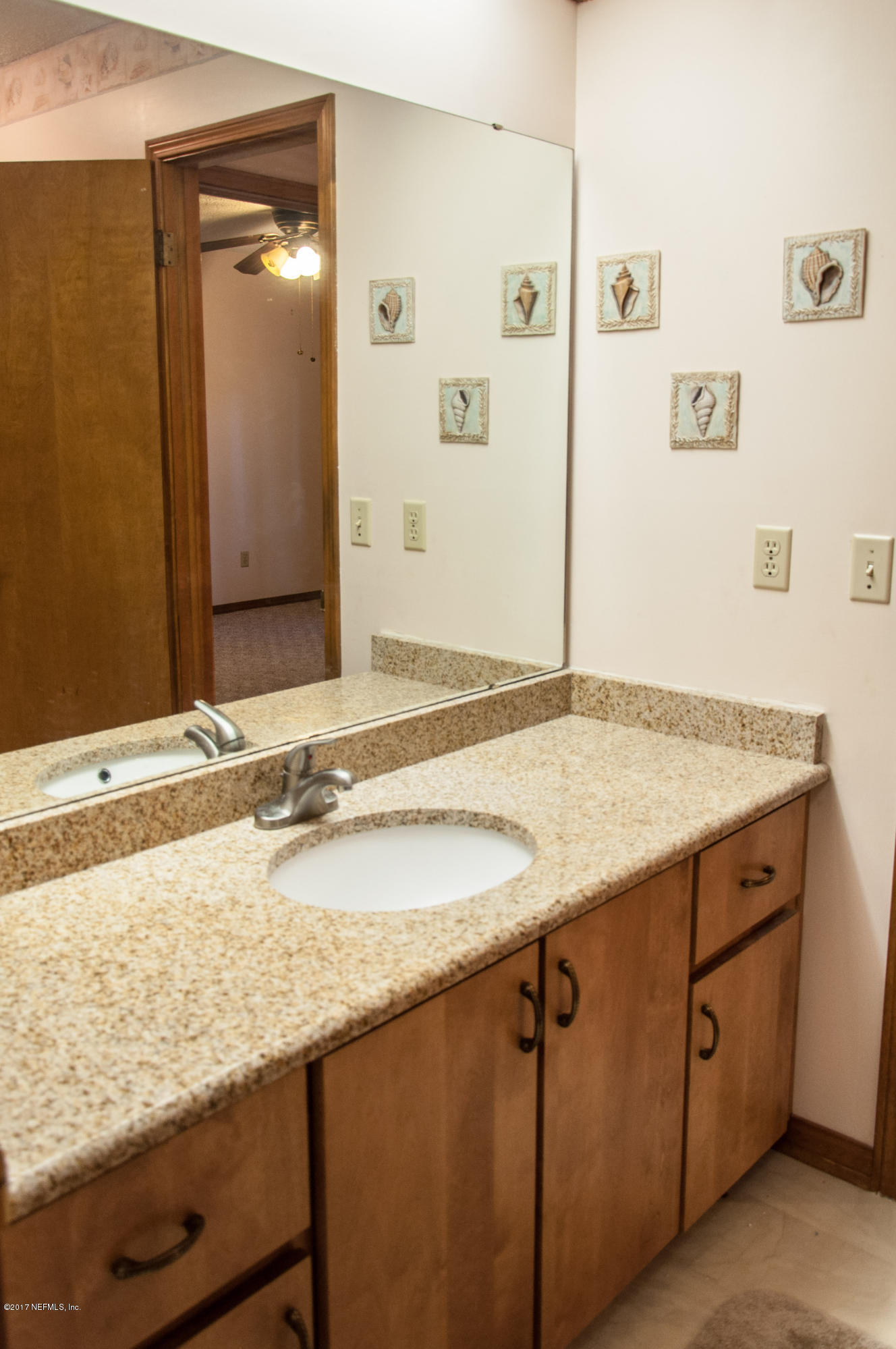5461 Spring Brook Road Jacksonville, FL 32277 - Photo 32 of 38 a bathroom with a granite countertop sink and a mirror