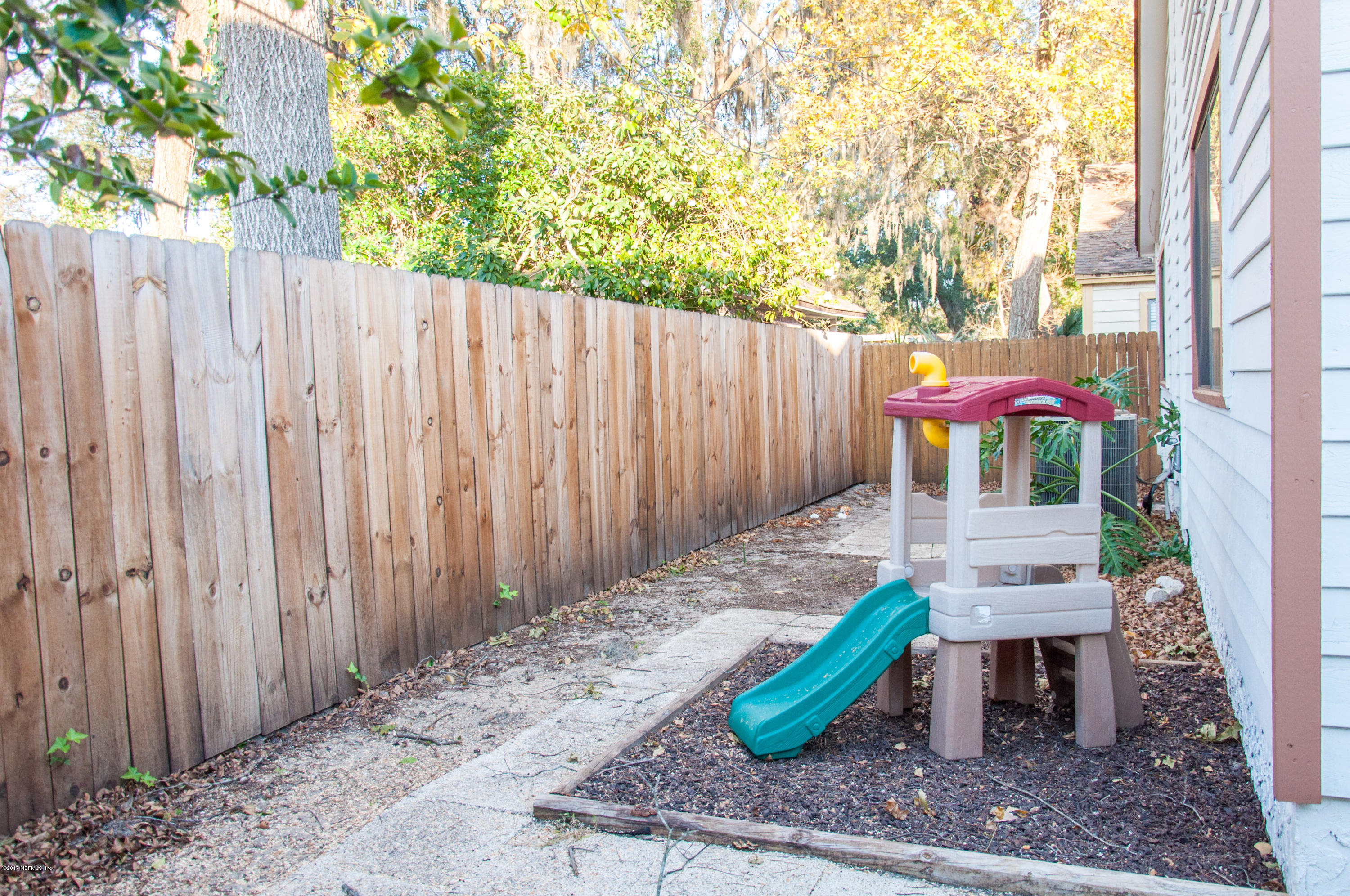 5461 Spring Brook Road Jacksonville, FL 32277 - Photo 36 of 38 a backyard of a house with table and chairs