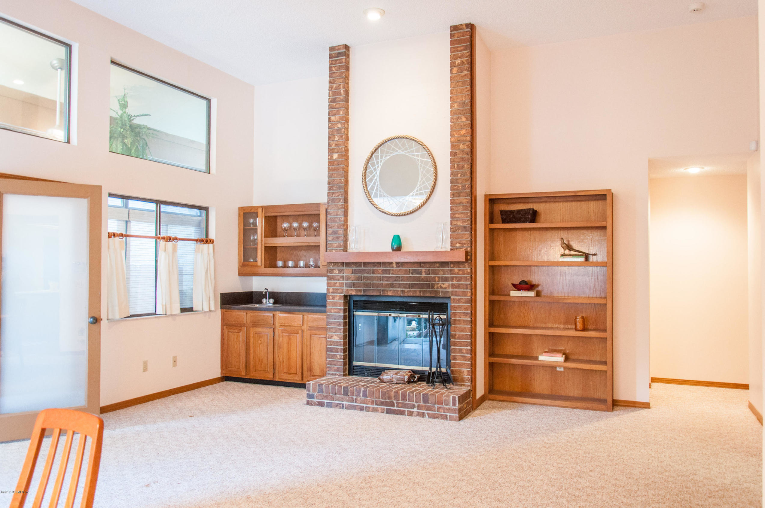5461 Spring Brook Road Jacksonville, FL 32277 - Photo 9 of 38 a view of an empty room with a fireplace and a window