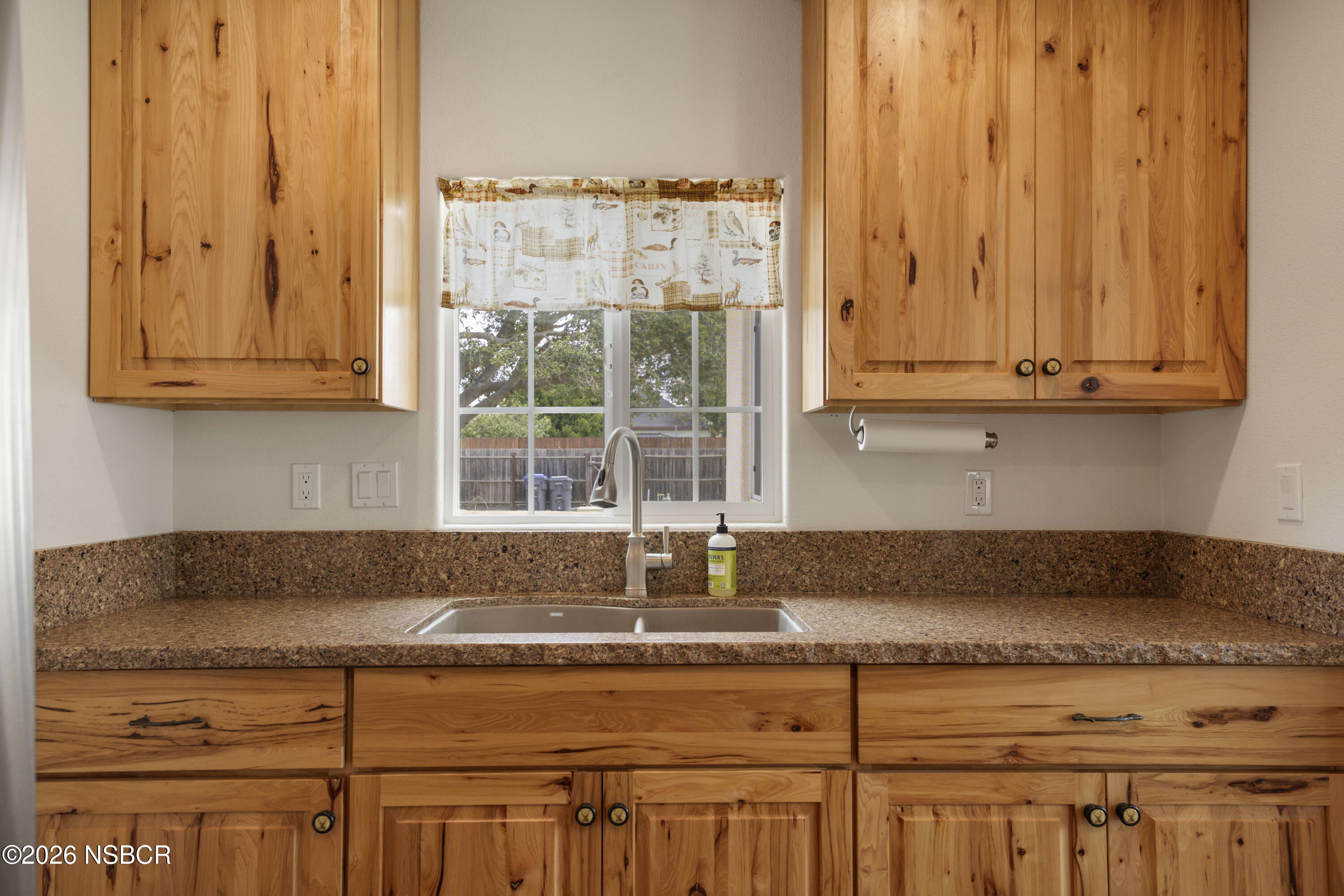138 North E Street Lompoc, CA 93436 - Photo 14 of 35 a kitchen with a sink and cabinets