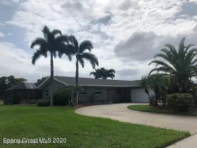 a view of a garden with a house