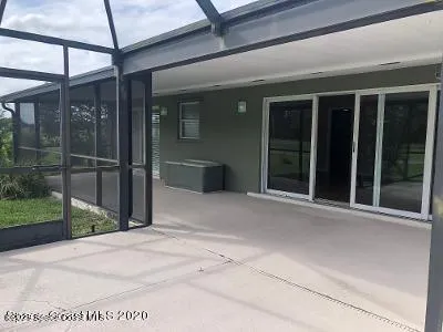 a view of backyard with large windows