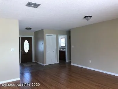 a view of a room with wooden floor and window