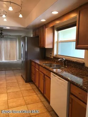 a kitchen with stainless steel appliances granite countertop a sink and a stove
