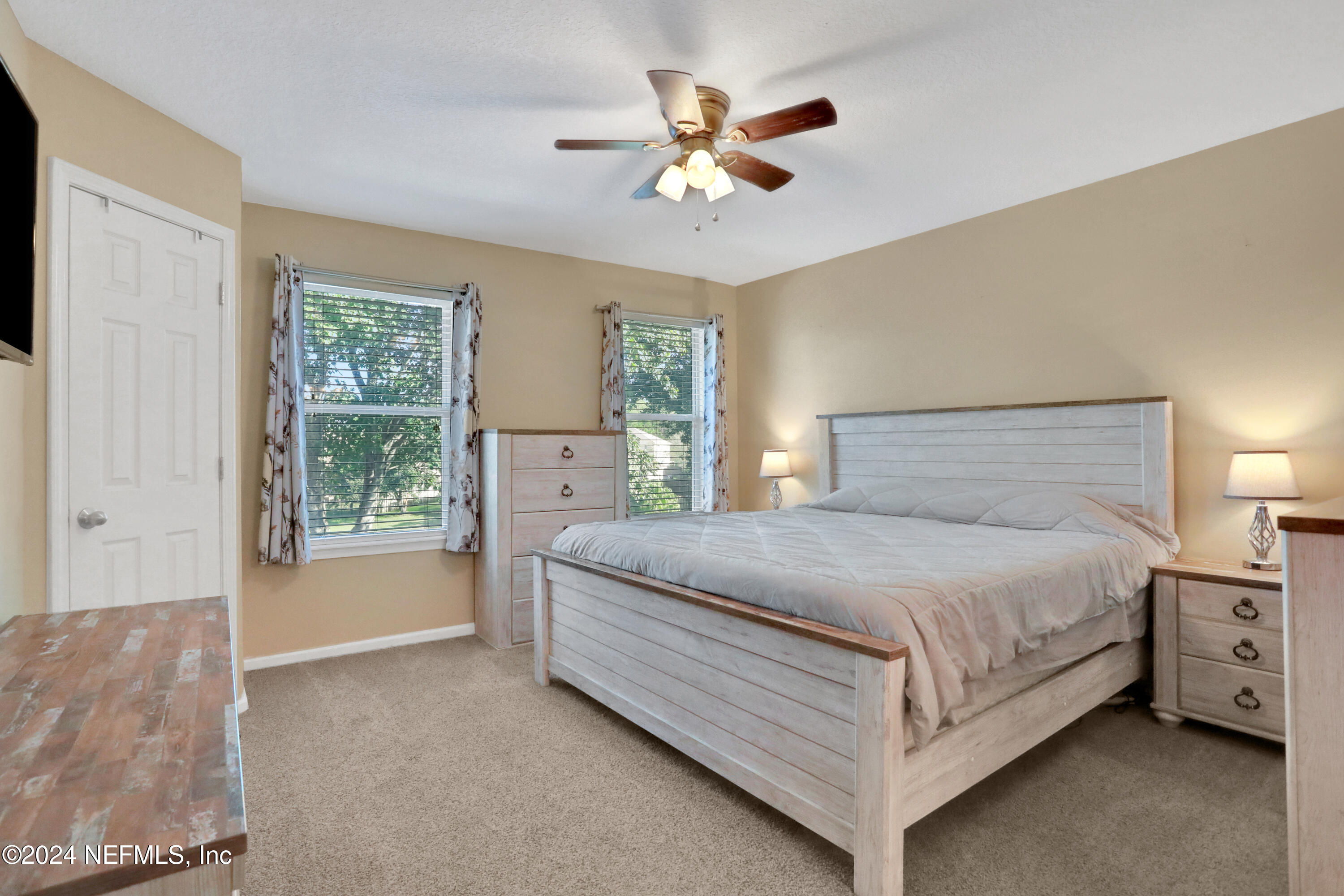 513 Scrub Jay Drive St. Augustine, FL 32092 - Photo 12 of 25 a bedroom with a bed chandelier and window
