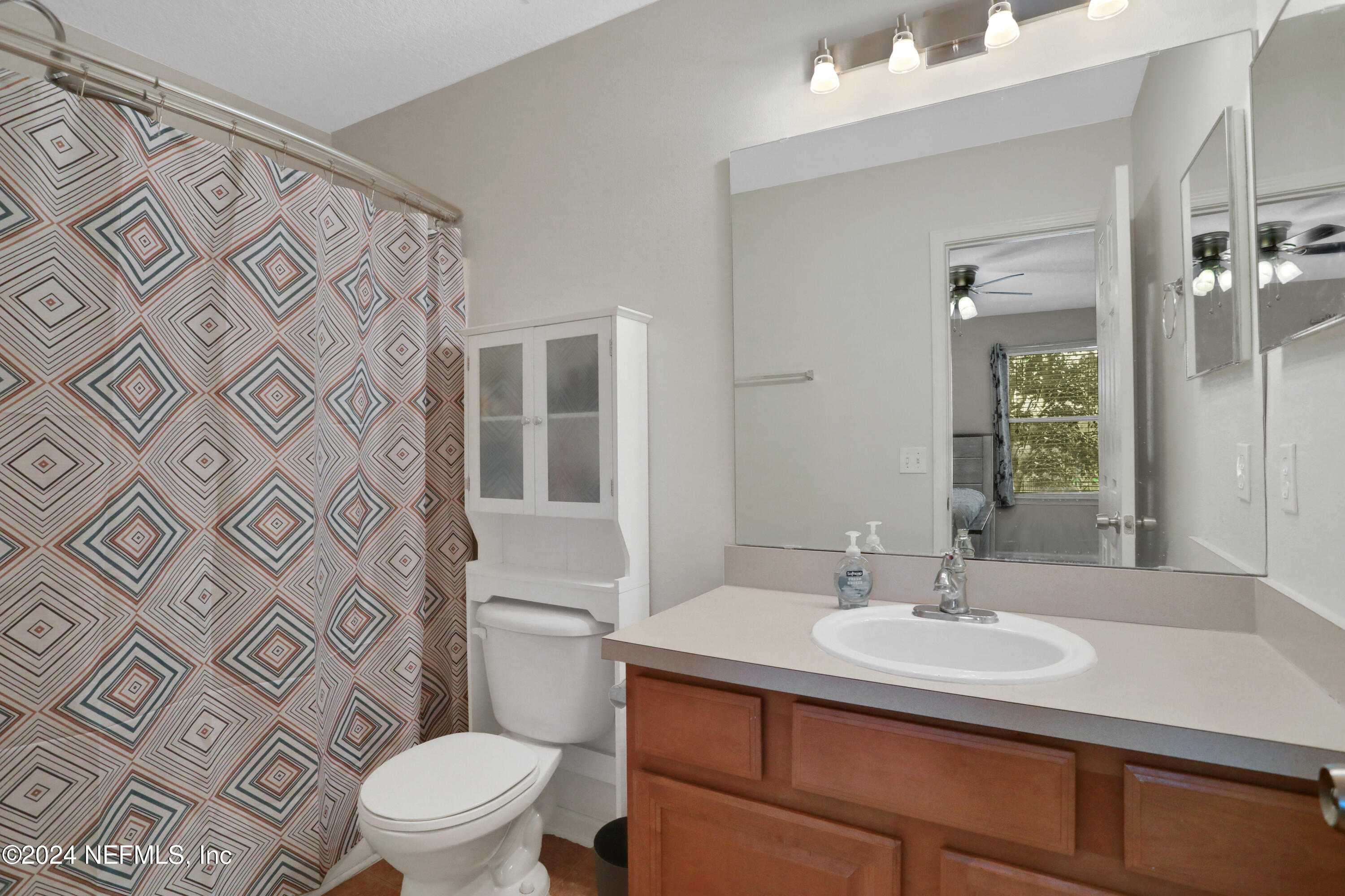 513 Scrub Jay Drive St. Augustine, FL 32092 - Photo 13 of 25 a bathroom with a sink toilet and shower
