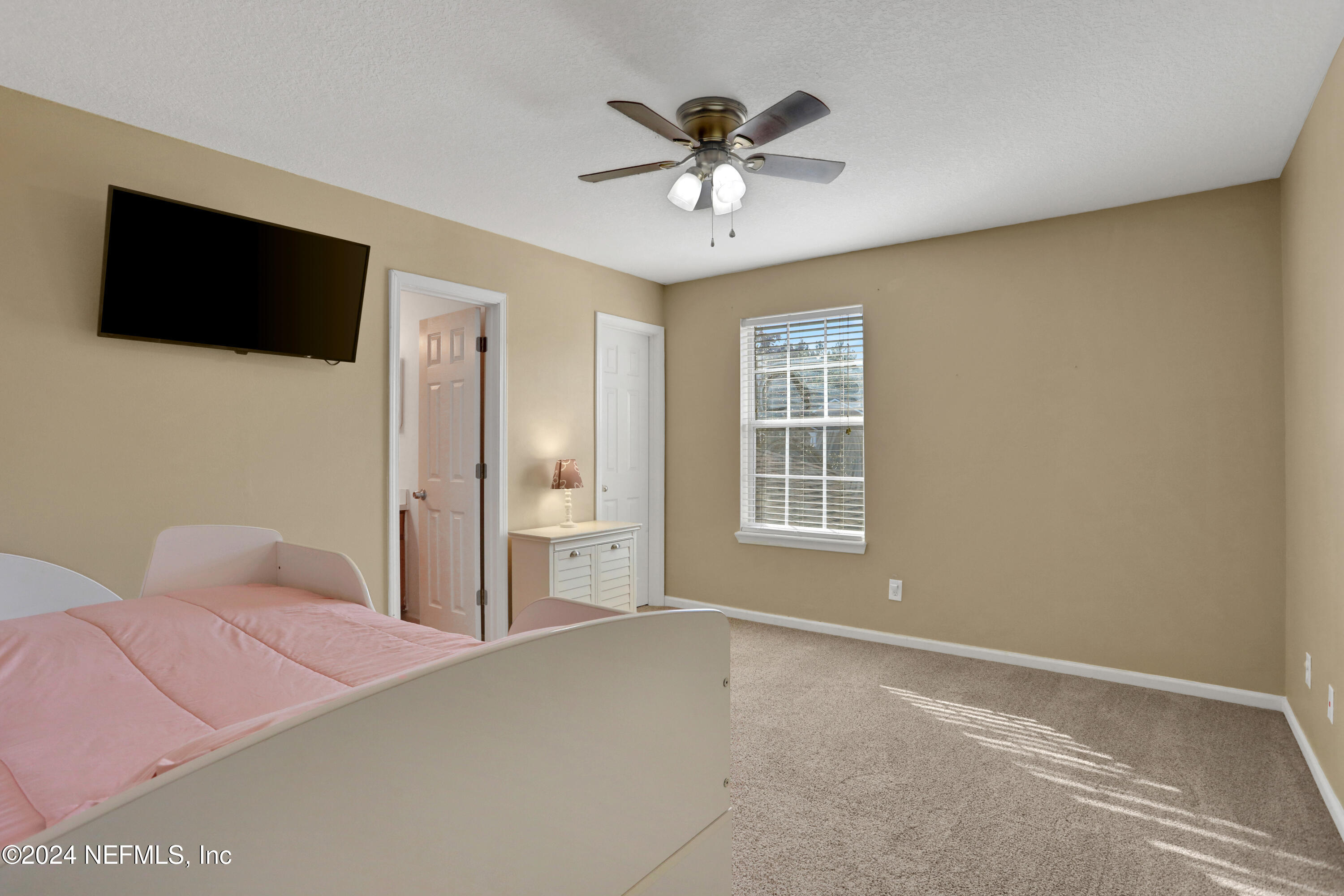 513 Scrub Jay Drive St. Augustine, FL 32092 - Photo 14 of 25 a bedroom with a bed and a flat screen tv