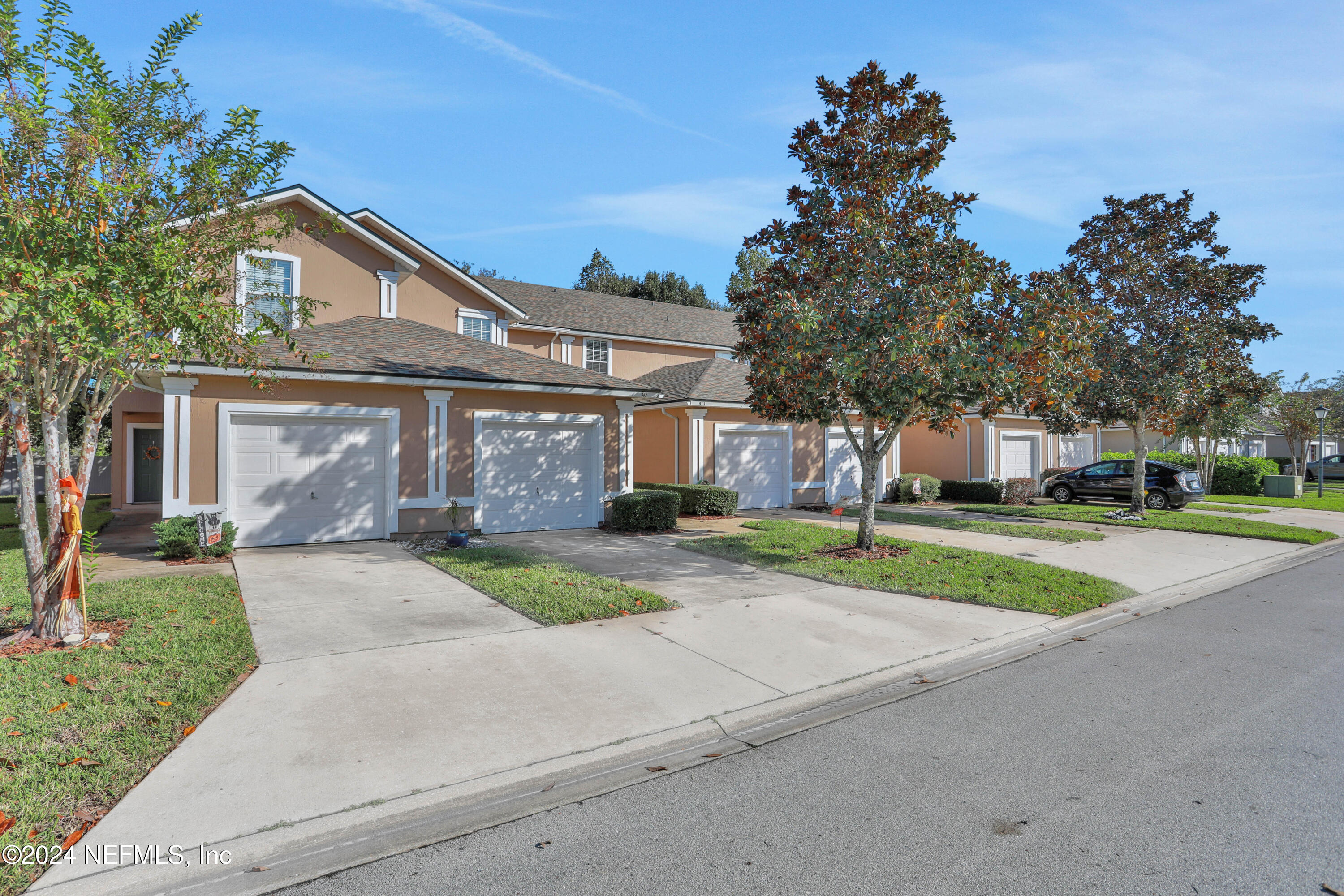 513 Scrub Jay Drive St. Augustine, FL 32092 - Photo 20 of 25 a front view of a house with a yard and garage