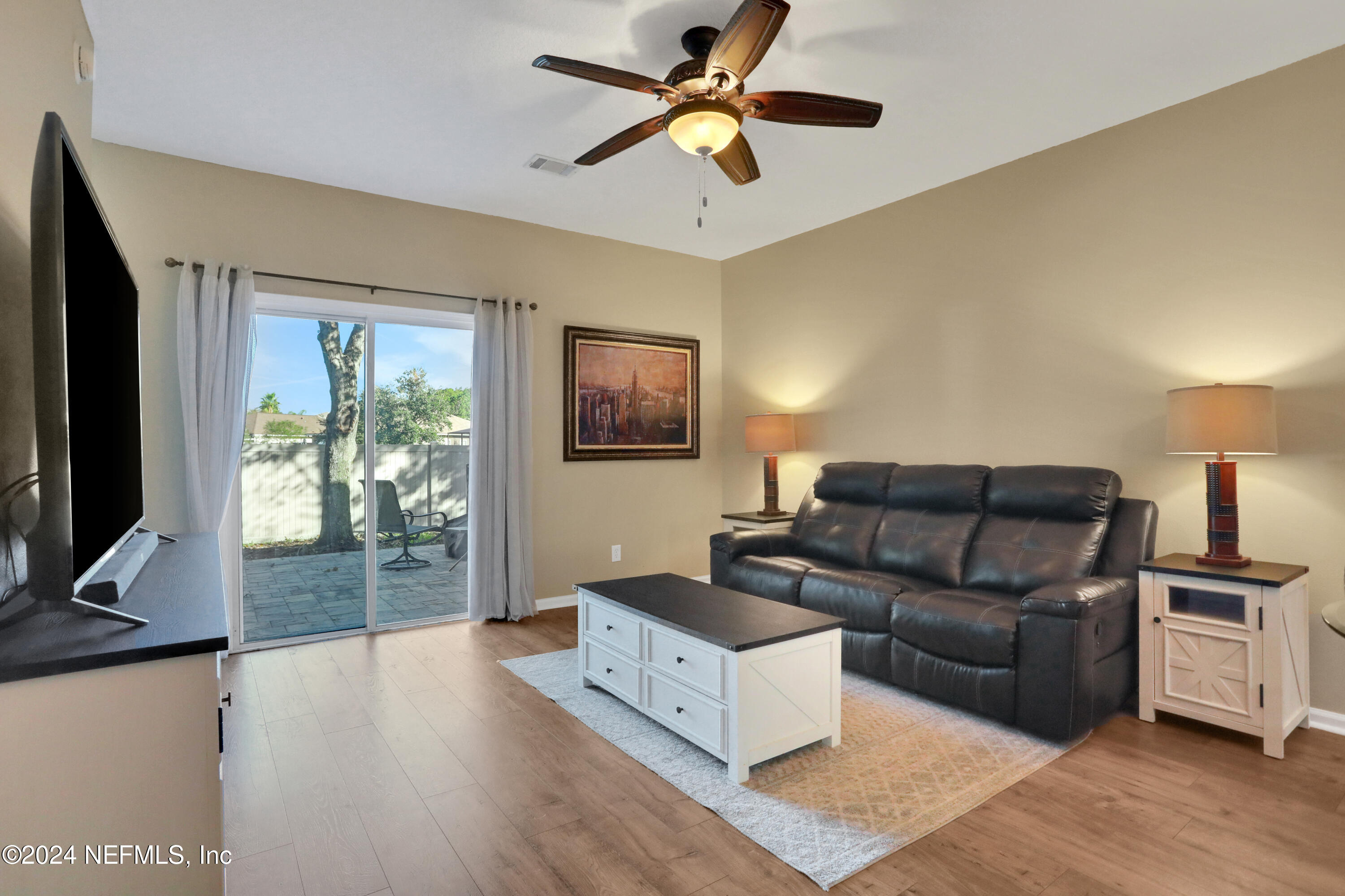 513 Scrub Jay Drive St. Augustine, FL 32092 - Photo 2 of 25 a living room with furniture and a flat screen tv
