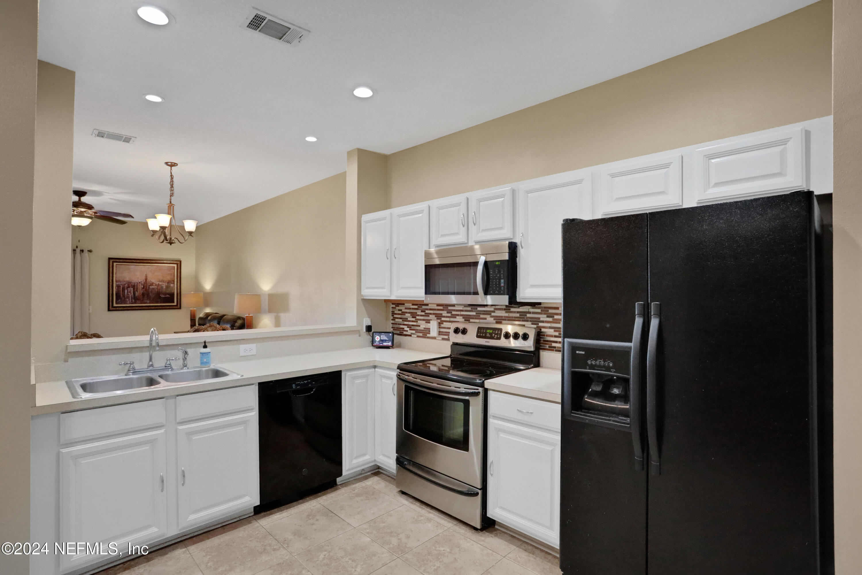 513 Scrub Jay Drive St. Augustine, FL 32092 - Photo 5 of 25 a kitchen with stainless steel appliances a refrigerator stove and sink