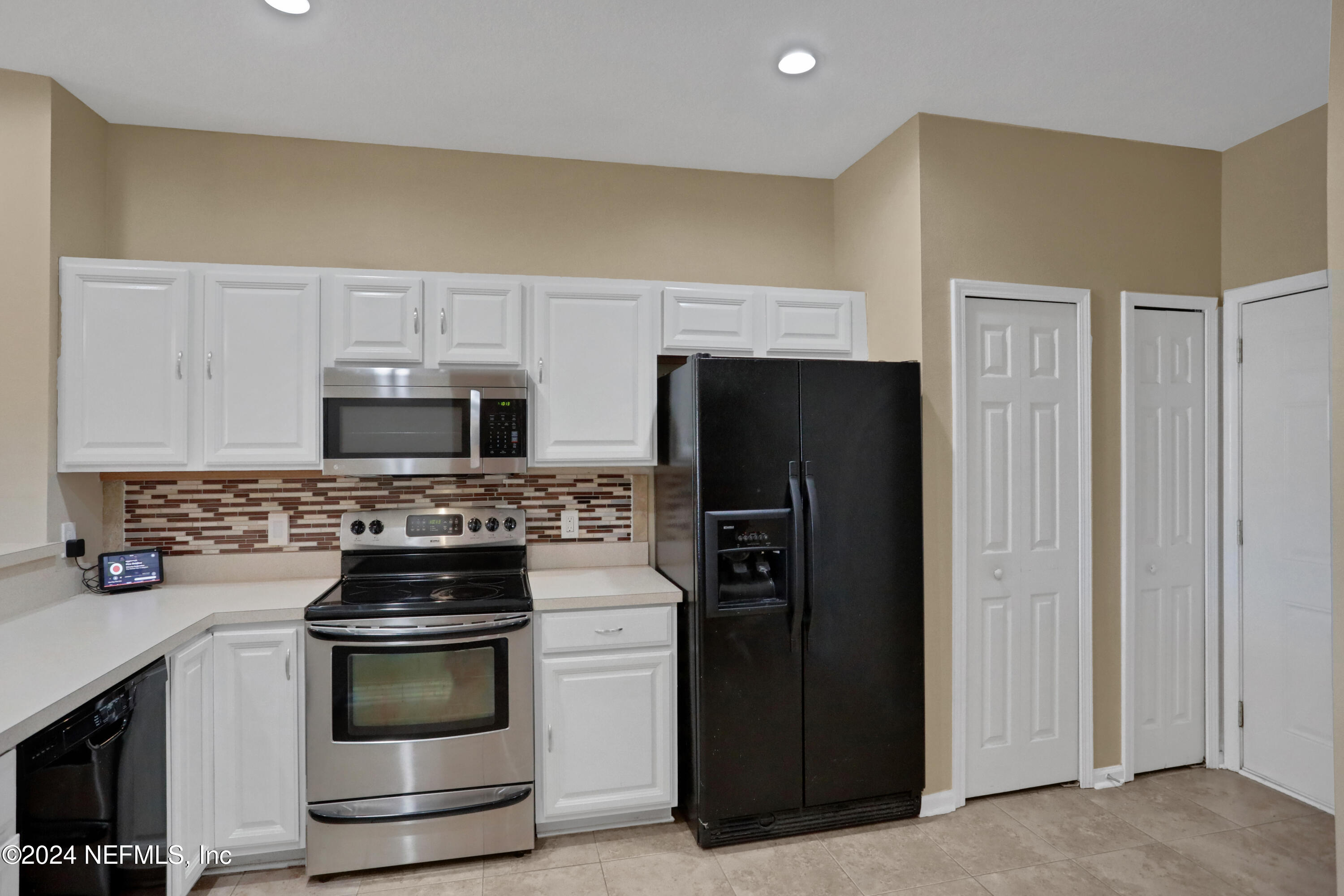 513 Scrub Jay Drive St. Augustine, FL 32092 - Photo 6 of 25 a kitchen with stainless steel appliances a stove microwave and refrigerator