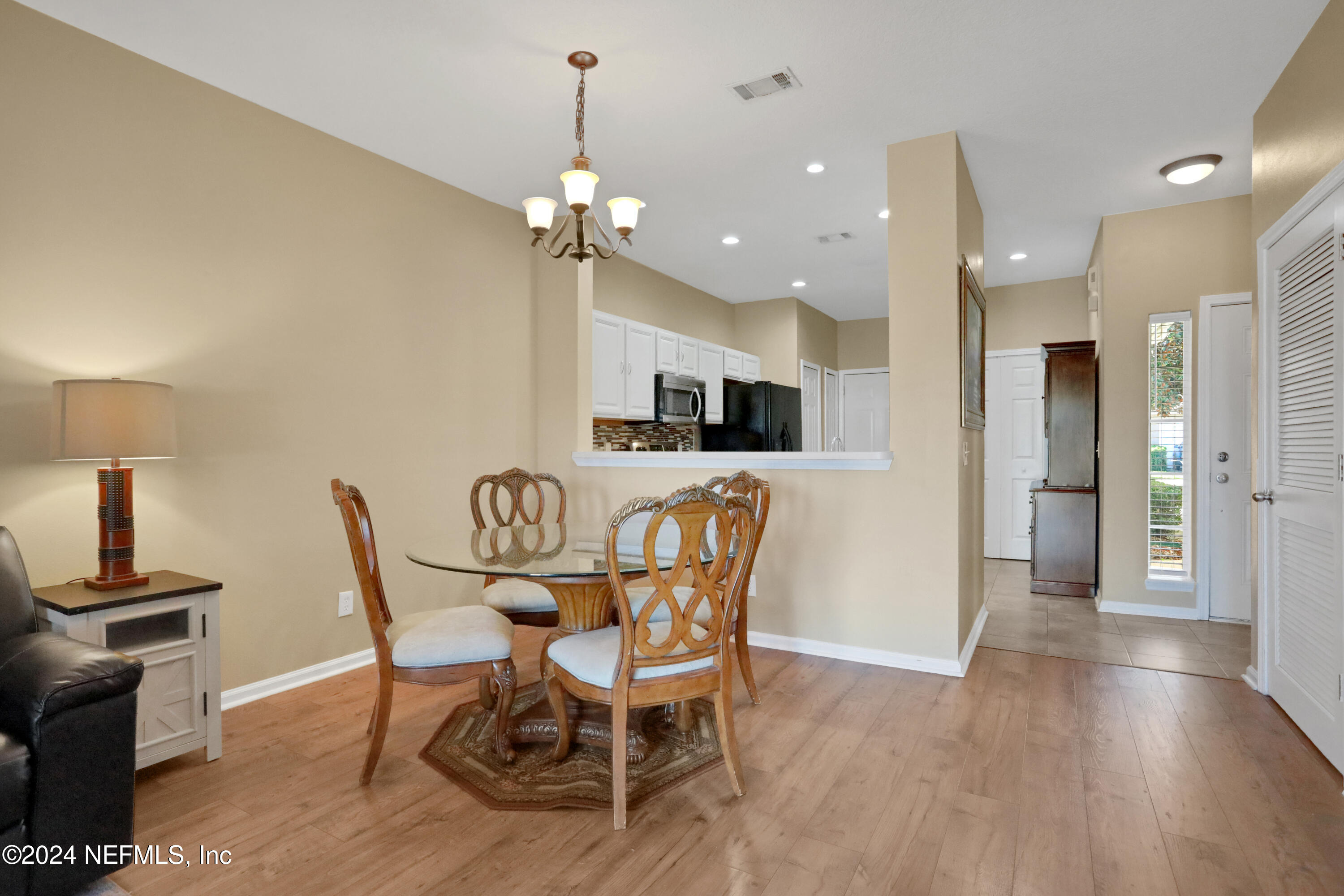 513 Scrub Jay Drive St. Augustine, FL 32092 - Photo 8 of 25 a view of a dining room with furniture and wooden floor