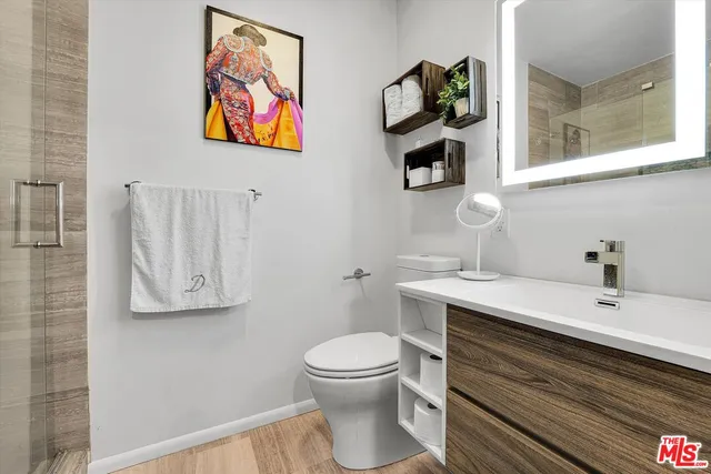 a bathroom with a toilet a sink and mirror