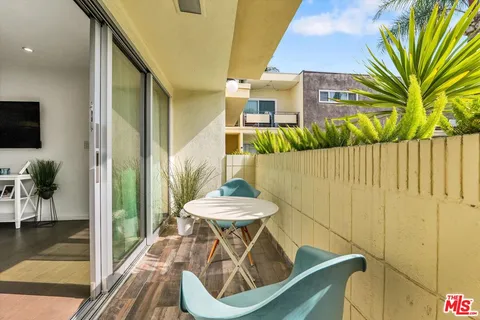 a view of balcony with furniture