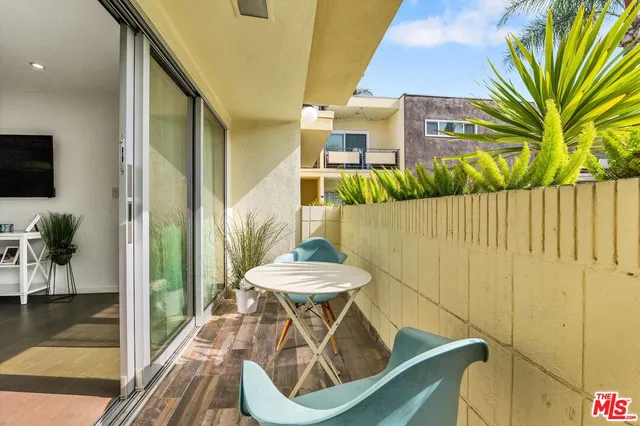 a view of balcony with furniture