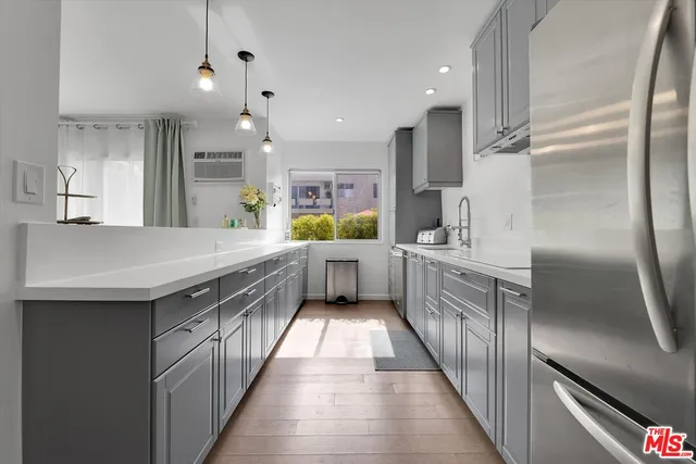 a kitchen with stainless steel appliances a sink and a refrigerator