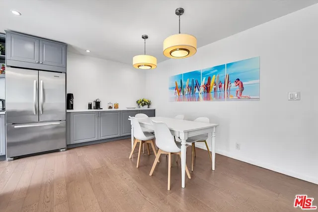 a kitchen with stainless steel appliances granite countertop a sink and a refrigerator