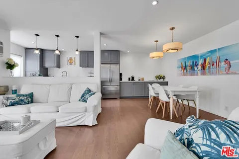 a living room with furniture kitchen view and a dining table