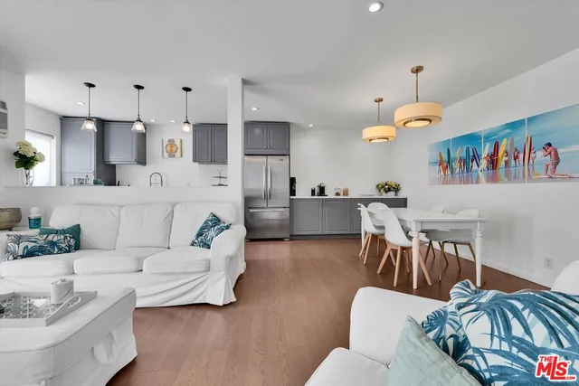 a living room with furniture kitchen view and a dining table