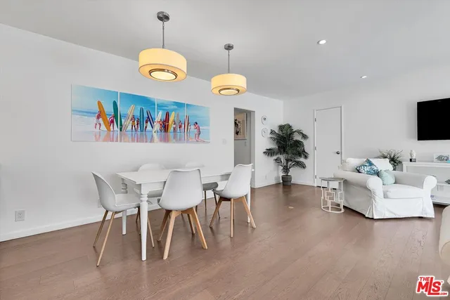 a view of a dining room with furniture wooden floor and a chandelier