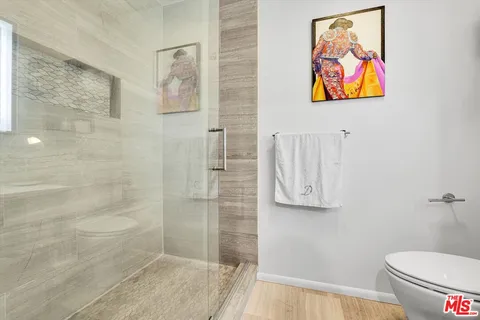 a bathroom with a toilet and a shower