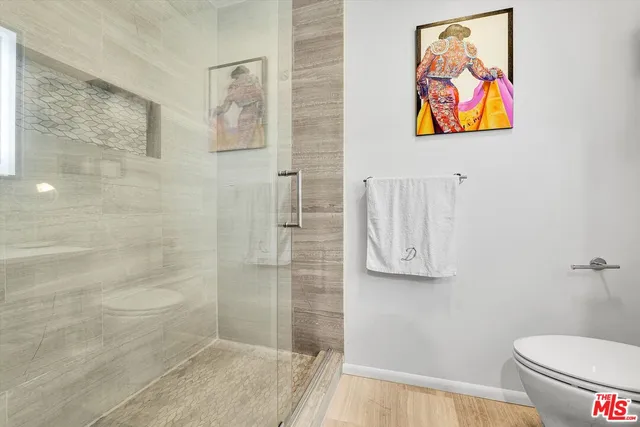 a bathroom with a toilet and a shower