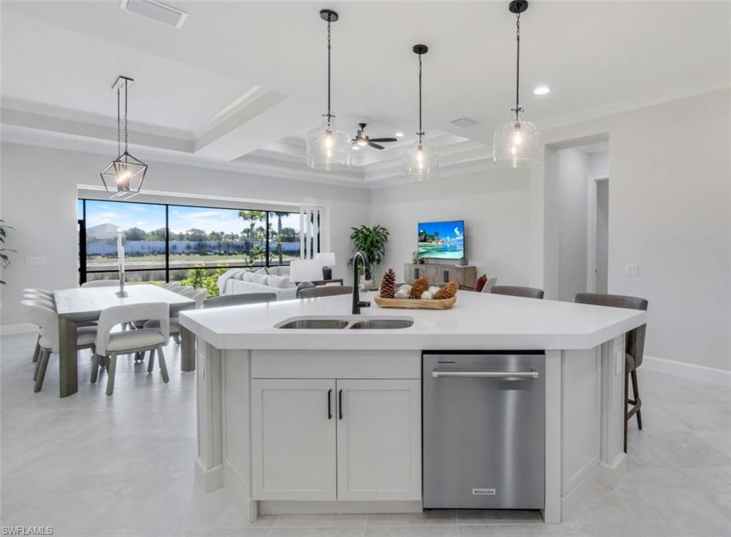 8850 Calypso Court Naples, FL 34113 - Photo 41 of 41 Kitchen featuring dishwasher, pendant lighting, open floor plan, white cabinets, and recessed lighting